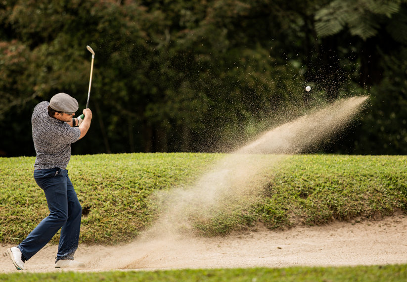 Golf swing out of sand bunker